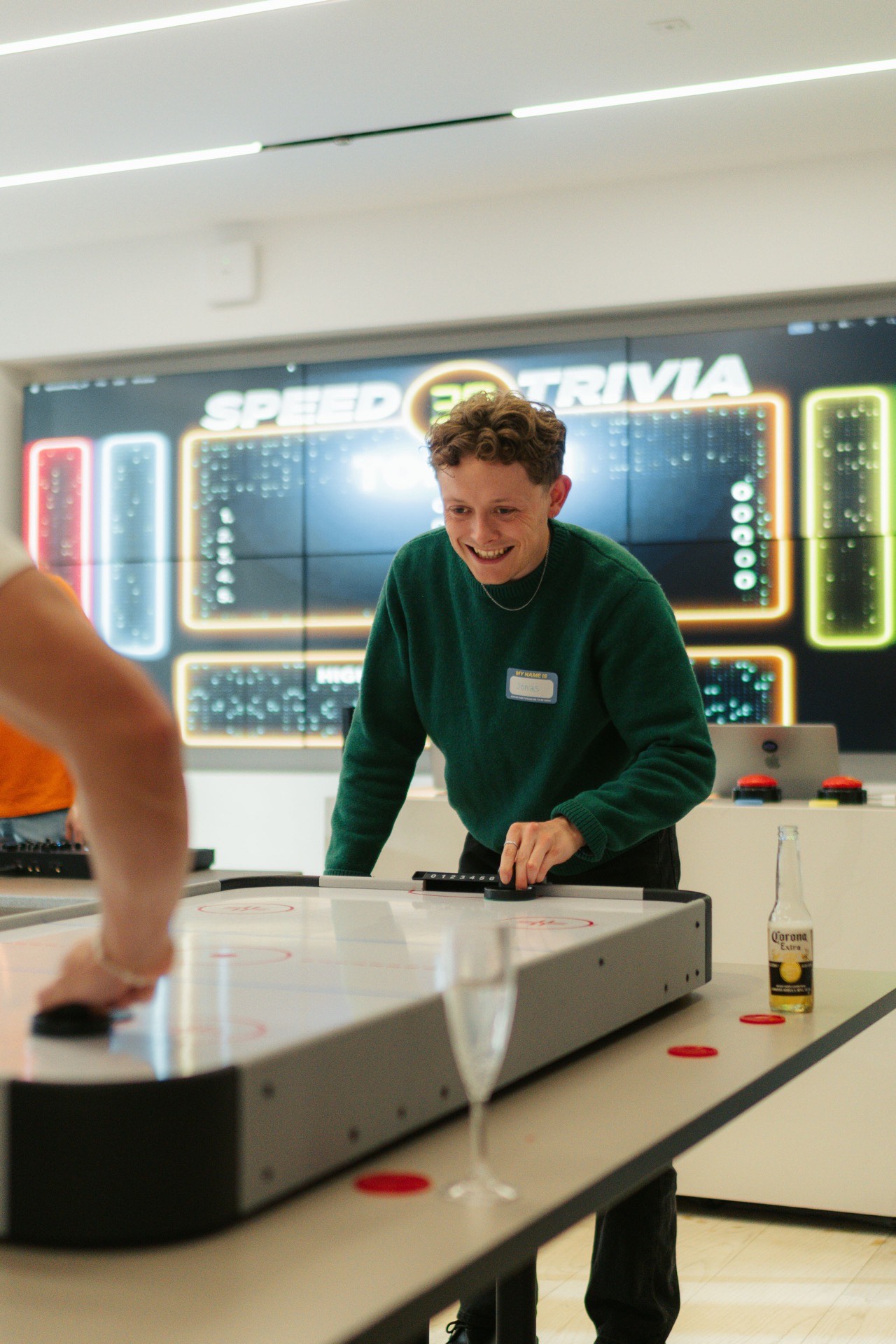 Guest playing air hockey at gaming station